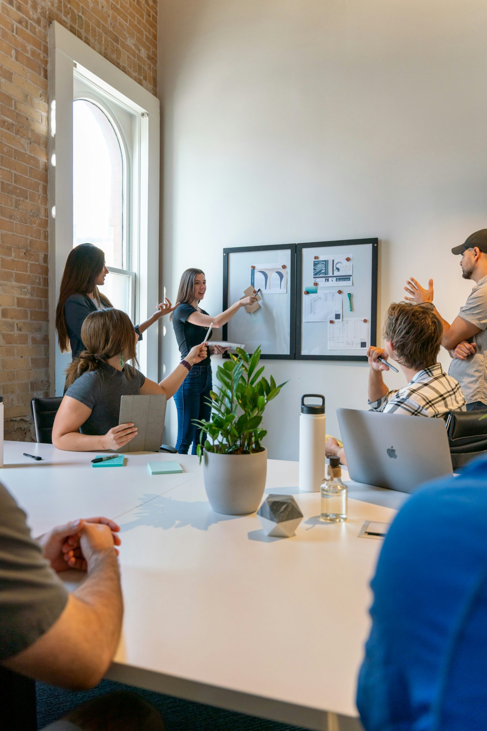 A team planning a project together at a whiteboard in a bright office